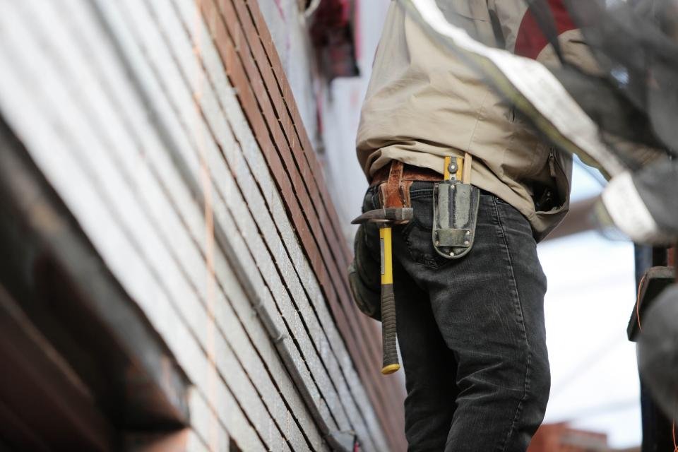 A tradesman with tools on his belt